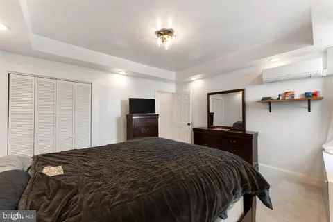 a bedroom with a bed and a television