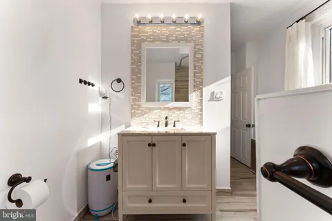 a bathroom with a sink a mirror and a toilet