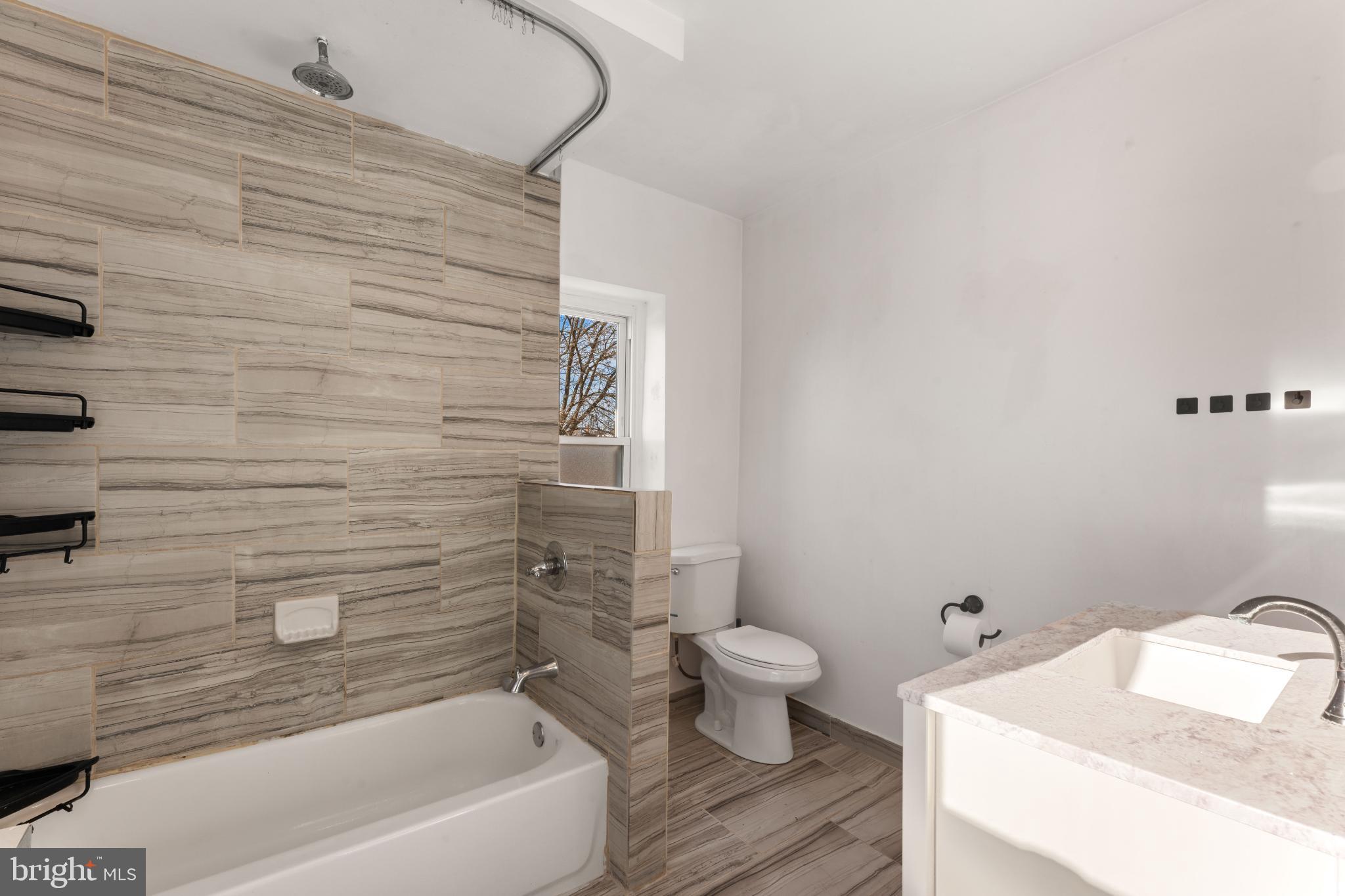 4618 Smick Street Philadelphia, PA 19127 - Photo 24 of 32 a bathroom with a sink and a bathtub