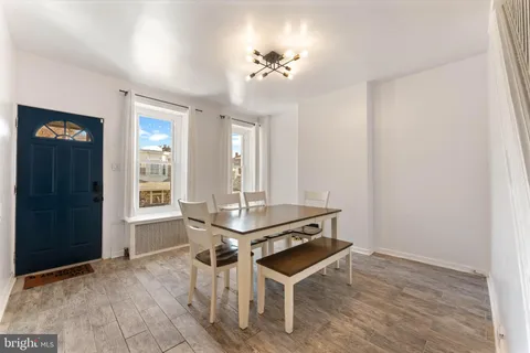 a view of a room with furniture and wooden floor