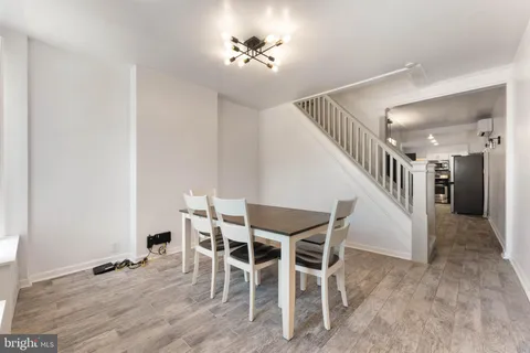 a view of a livingroom with furniture and stairs