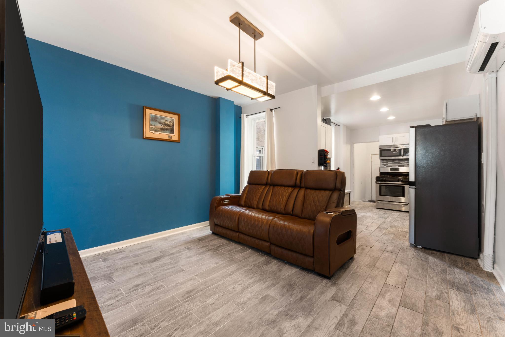 4618 Smick Street Philadelphia, PA 19127 - Photo 9 of 32 a living room with a couch and a chandelier