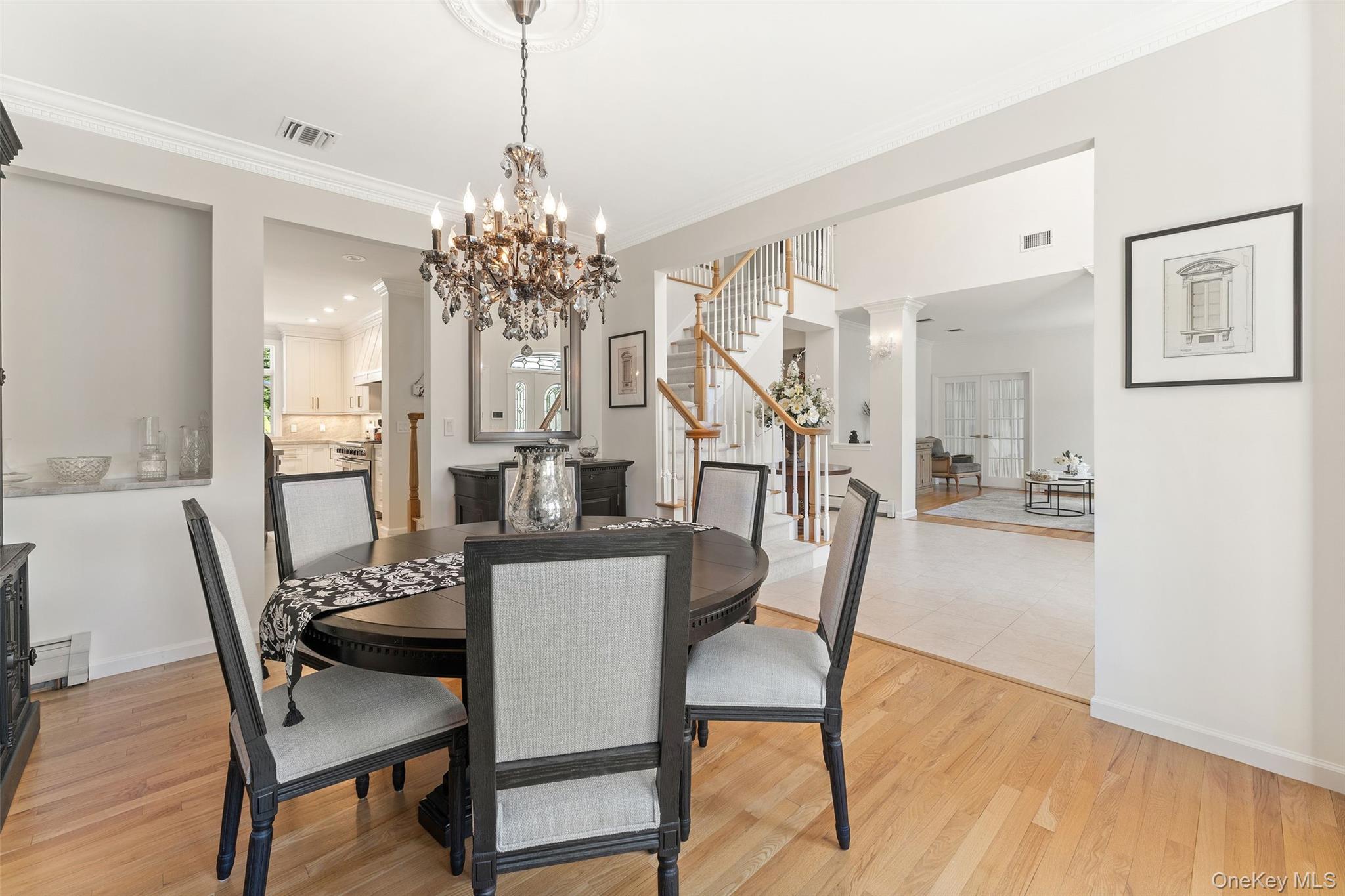 22 Perrin's Peak Road Stony Point, NY 10980 - Photo 25 of 47 Dining room with stairway, crown molding, a chandelier, and light wood finished floors