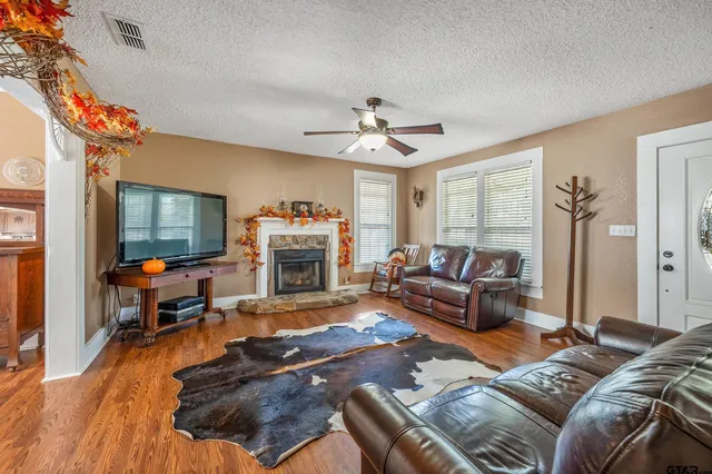 a living room with furniture and a fireplace