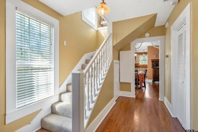 a view of entryway and hall with wooden floor