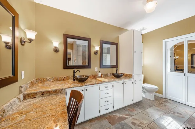 a bathroom with a double vanity sink and a mirror