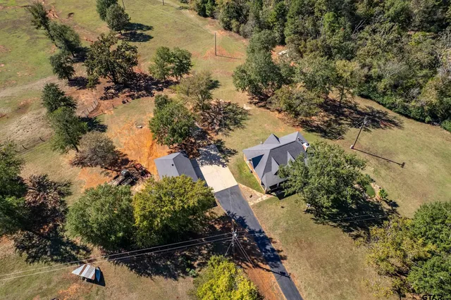 an aerial view of a house with a yard