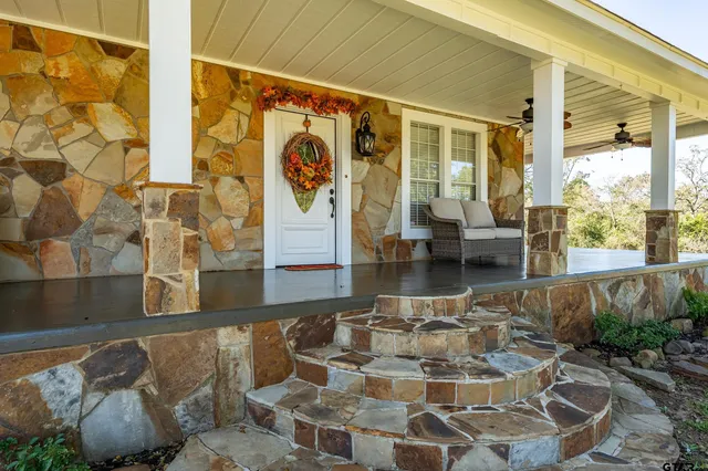 a view of a patio with couches chairs and potted plants