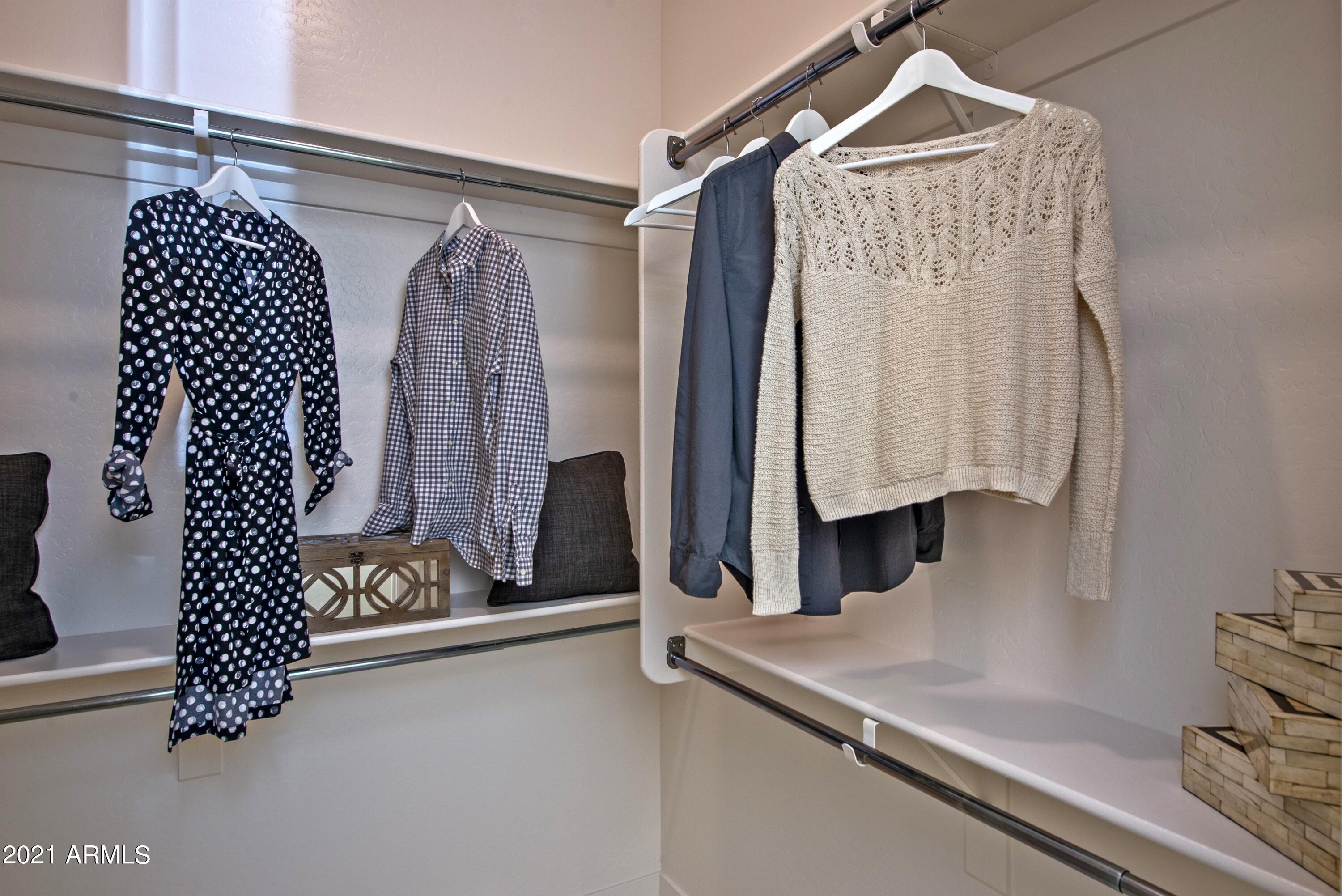 6565 East Thomas Road, Unit 1042 Scottsdale, AZ 85251 - Photo 11 of 22 a view of walk in closet with clothes and shoes
