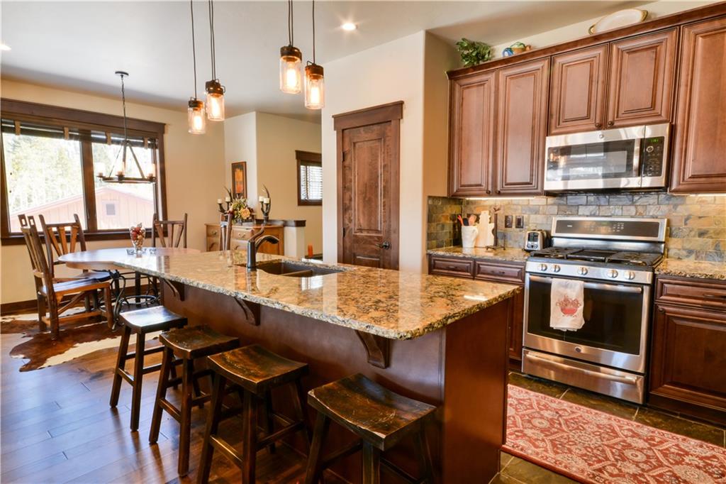 869 Independence Road, Unit 4B Keystone, CO 80435 - Photo 22 of 25 a kitchen with a table chairs stove and kitchen view