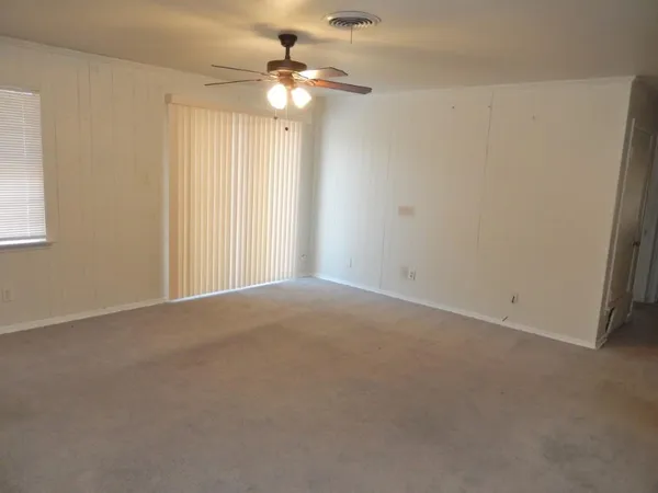 a view of a livingroom with a chandelier fan