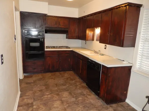 a kitchen with a sink and cabinets
