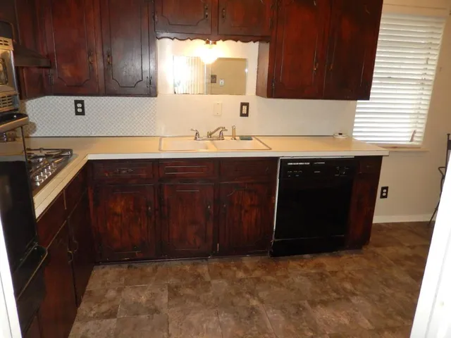 a kitchen with a sink a cabinets and window