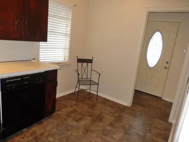 a bathroom with a granite countertop toilet sink and mirror