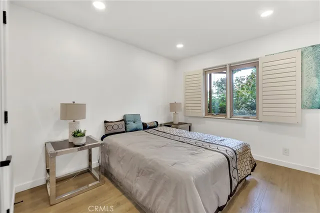 a spacious bedroom with a bed and a window