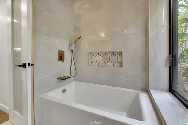 a bath tub sitting next to a white sink