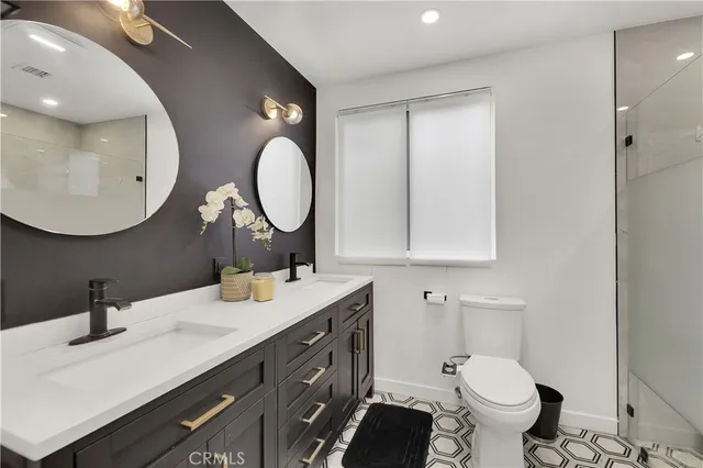 a bathroom with a toilet sink and mirror