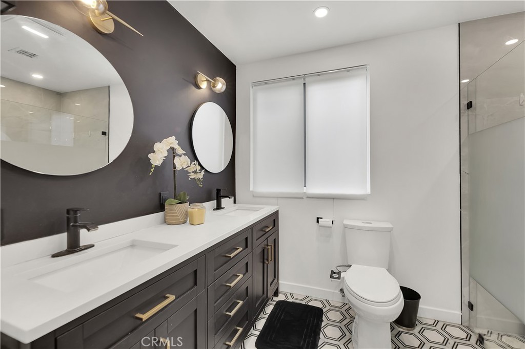 6409 Graves Avenue Lake Balboa, CA 91406 - Photo 21 of 50 a bathroom with a toilet sink and mirror