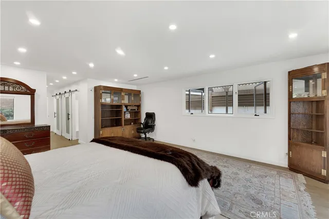 a bedroom with a bed and a view of kitchen