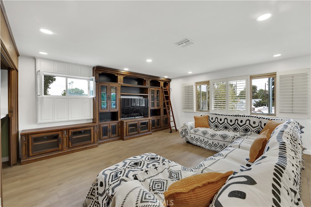 6409 Graves Avenue Lake Balboa, CA 91406 - Photo 28 of 50 a living room with furniture and a flat screen tv
