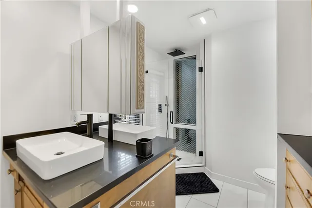 a view of a kitchen with a sink and a refrigerator