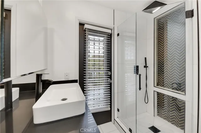 a bathroom with a shower and a sink