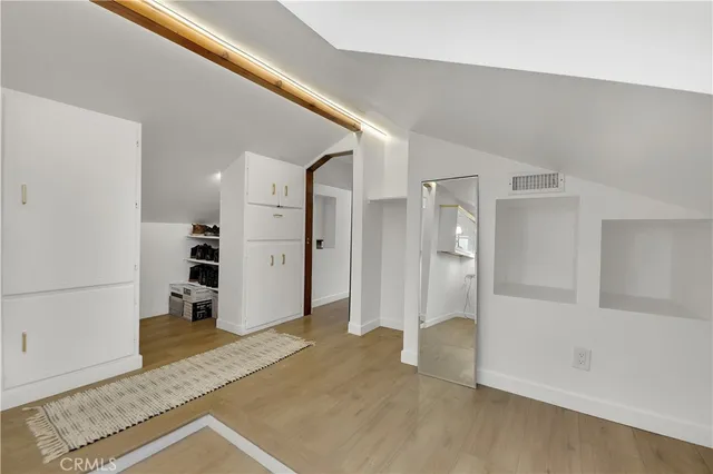 a view of a big room with closet and windows