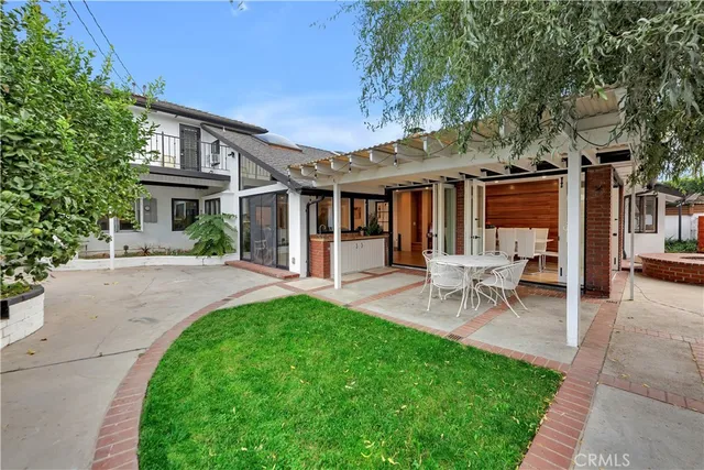 a view of a house with a backyard and a patio