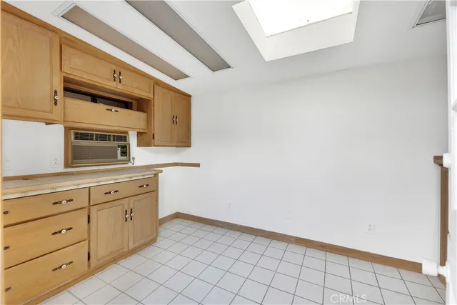 a kitchen with granite countertop white cabinets stainless steel appliances and a sink
