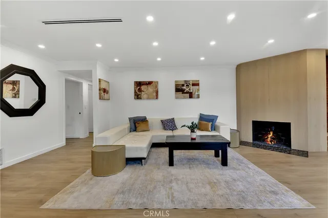 a living room with furniture a fireplace and a large window