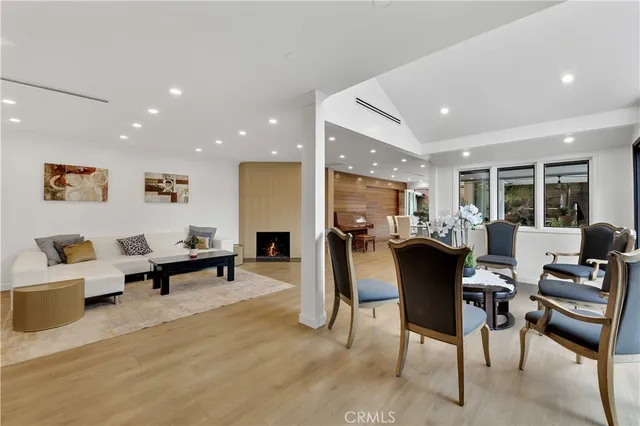 a living room with furniture a dining table and chairs with kitchen view