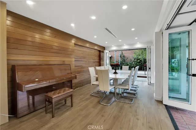 a dining room with furniture and wooden floor