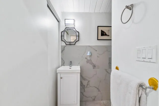 a bathroom with a tub sink and mirror
