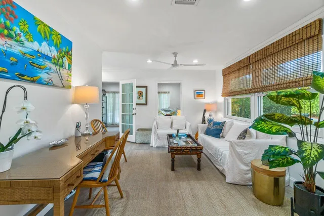 a living room with furniture and a potted plant