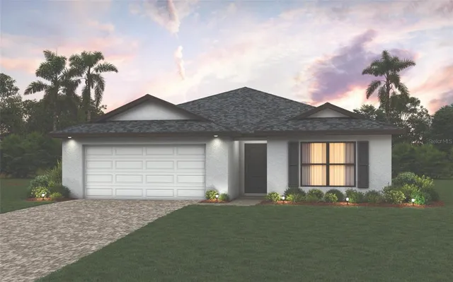 a front view of a house with a garden and yard