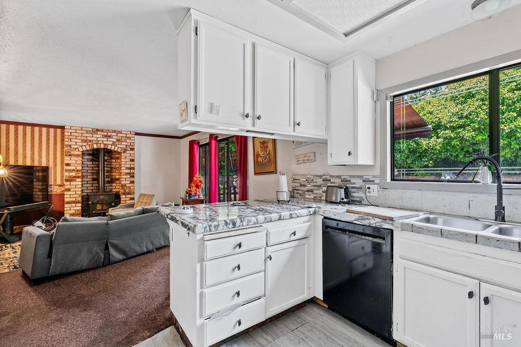 715 Placer Court Santa Rosa, CA 95401 - Photo 10 of 37 a kitchen that has a lot of cabinets in it and wooden floors