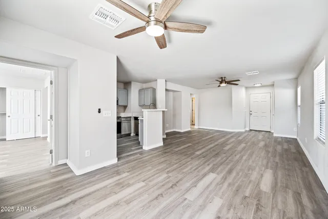 a view of empty room with wooden floor