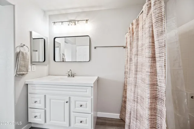 a bathroom with a sink vanity and a mirror