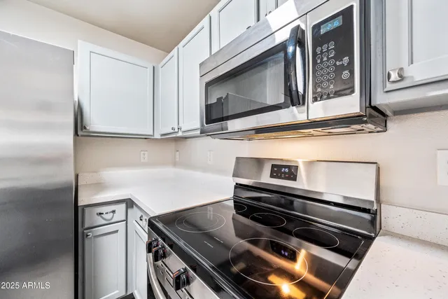 a kitchen with a stove microwave and sink