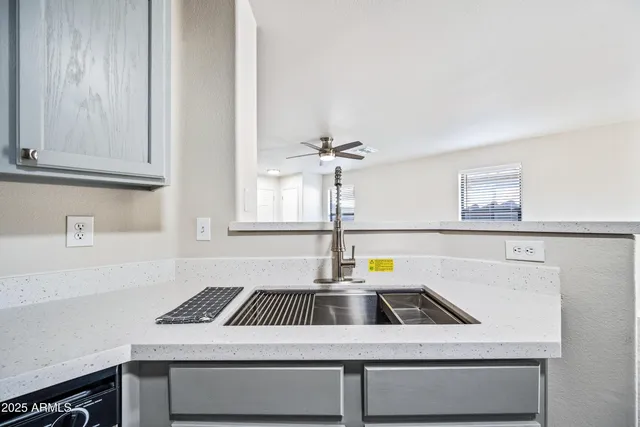 a kitchen that has a sink and a stove in it
