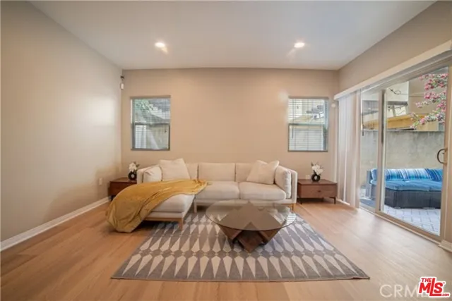 a spacious bedroom with a bed couch and a large window