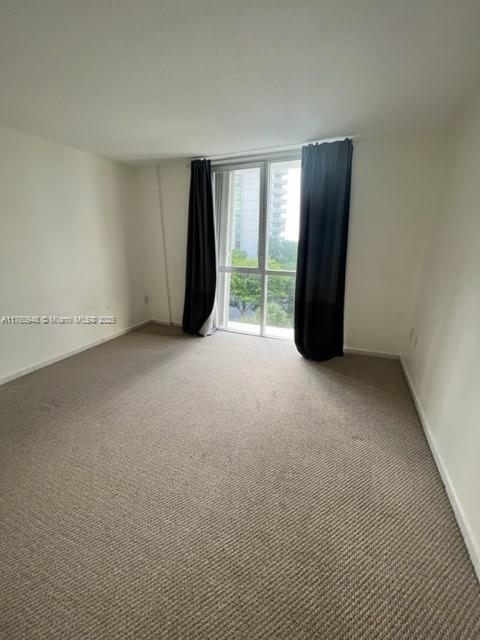 600 Grapetree Drive, Unit 6ES Key Biscayne, FL 33149 - Photo 12 of 21 a view of an empty room with glass door