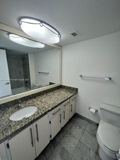 600 Grapetree Drive, Unit 6ES Key Biscayne, FL 33149 - Photo 14 of 21 a bathroom with a granite countertop sink a toilet and a mirror
