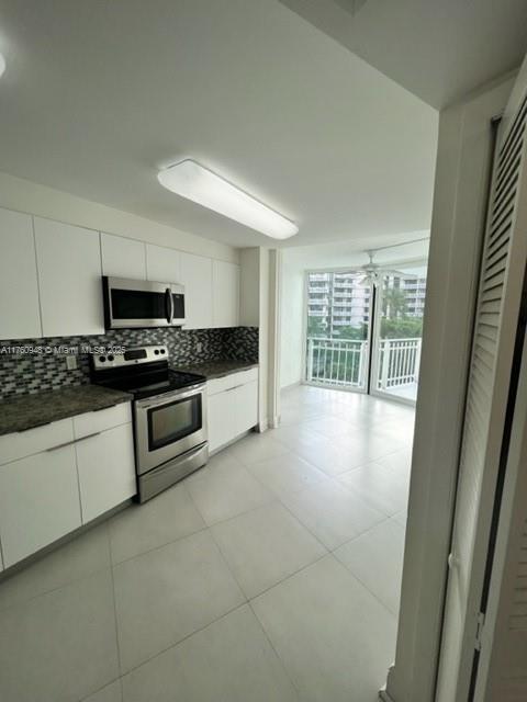 600 Grapetree Drive, Unit 6ES Key Biscayne, FL 33149 - Photo 7 of 21 a kitchen with granite countertop a stove a sink and a microwave