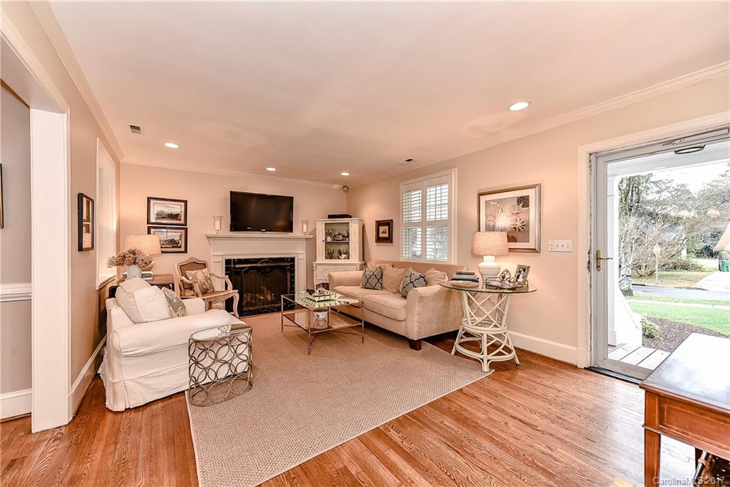 1028 Sedgefield Road Charlotte, NC 28209 - Photo 12 of 24 a living room with furniture wooden floor and a fireplace