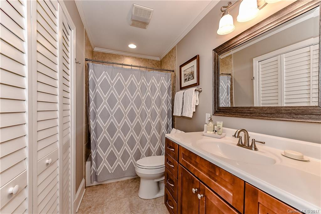 1028 Sedgefield Road Charlotte, NC 28209 - Photo 14 of 24 a bathroom with a sink a toilet and shower