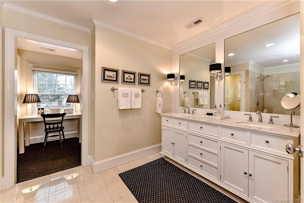 1028 Sedgefield Road Charlotte, NC 28209 - Photo 17 of 24 a spacious bathroom with a double vanity sink a mirror and a bathtub