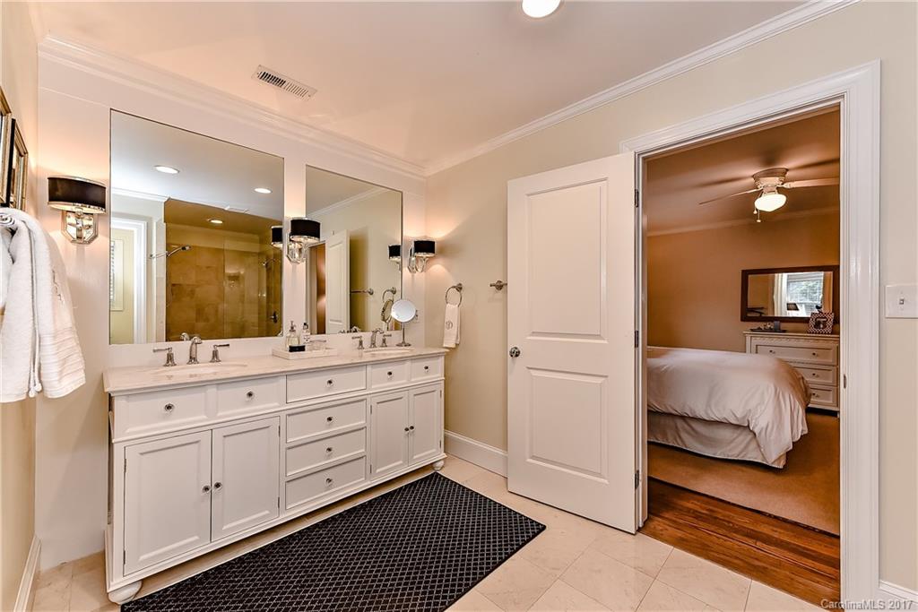1028 Sedgefield Road Charlotte, NC 28209 - Photo 20 of 24 a bathroom with a double vanity sink and mirror