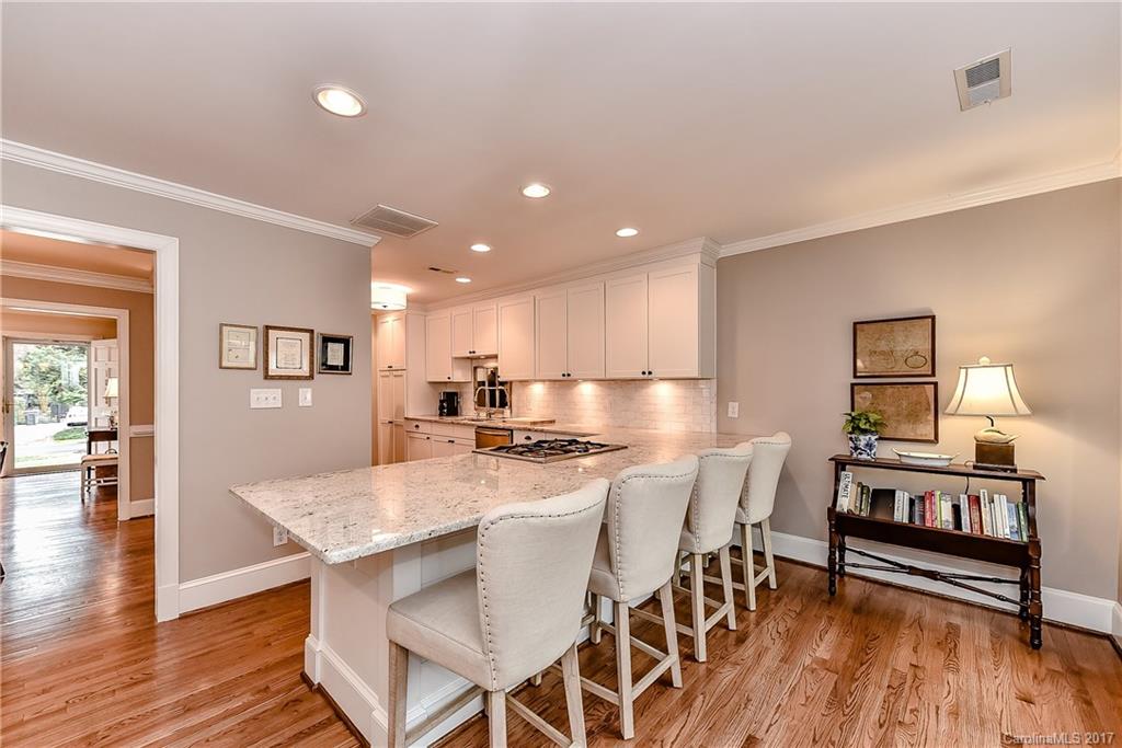 1028 Sedgefield Road Charlotte, NC 28209 - Photo 6 of 24 a kitchen with a dining table chairs and wooden floor