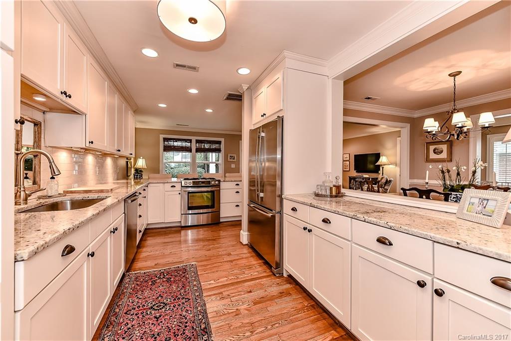 1028 Sedgefield Road Charlotte, NC 28209 - Photo 8 of 24 a large white kitchen with stainless steel appliances lots of counter space and a sink